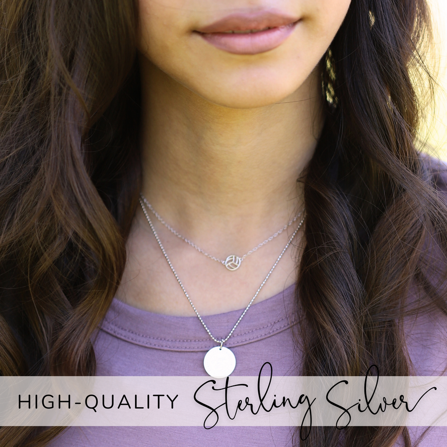 Model wearing tiny, dainty .925 silver Volleyball Necklace, layered with Charm Necklace.