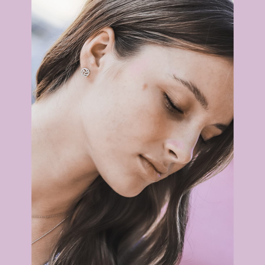 Model wearing tiny Volleyball earrings.
