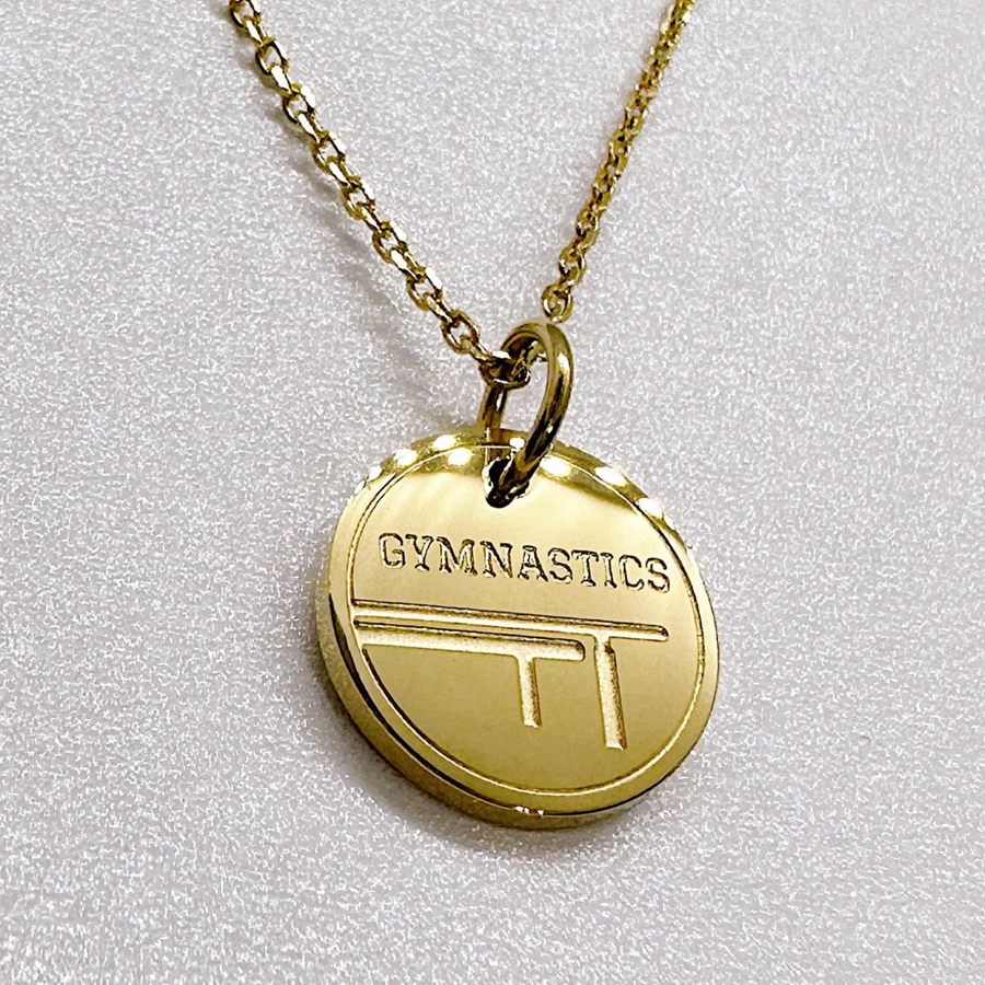 Dainty gymnastics necklace shown in gold. Gift for gymnast or gymnastics coach.