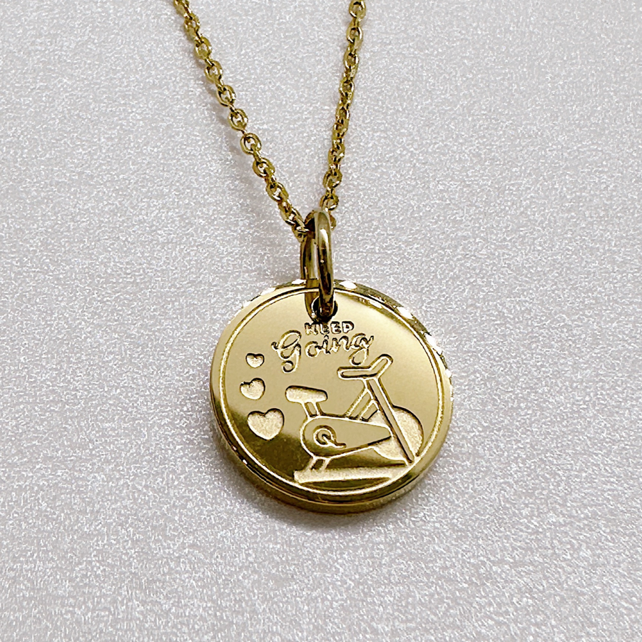 Gold indoor cycle fitness disc charm necklace.