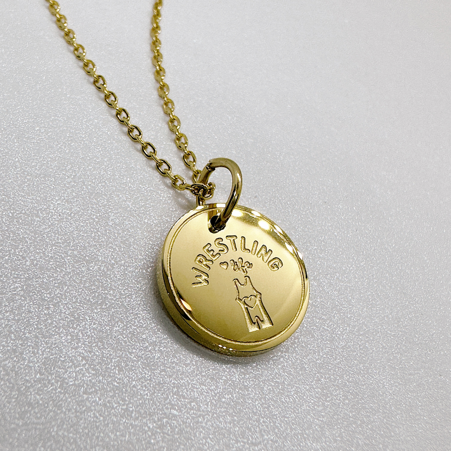 Gold girl's wrestling charm necklace.