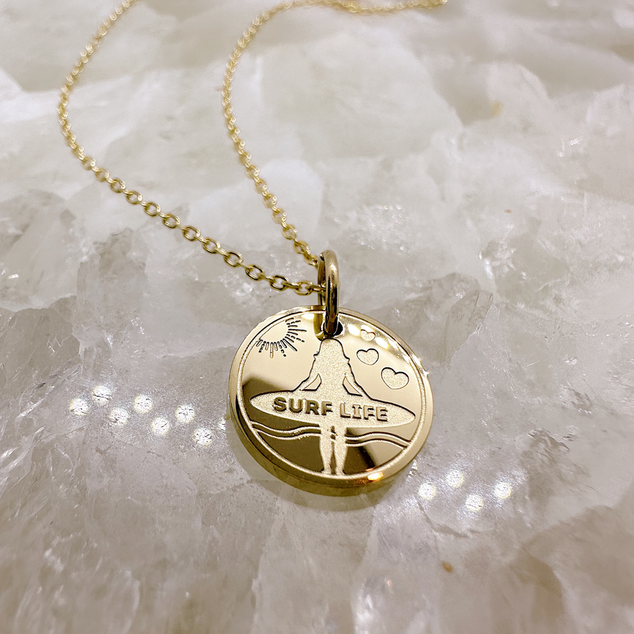 Gold surfer disc charm necklace.