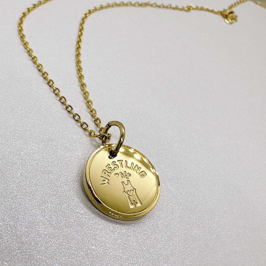 Gold girl's wrestling disc charm necklace.