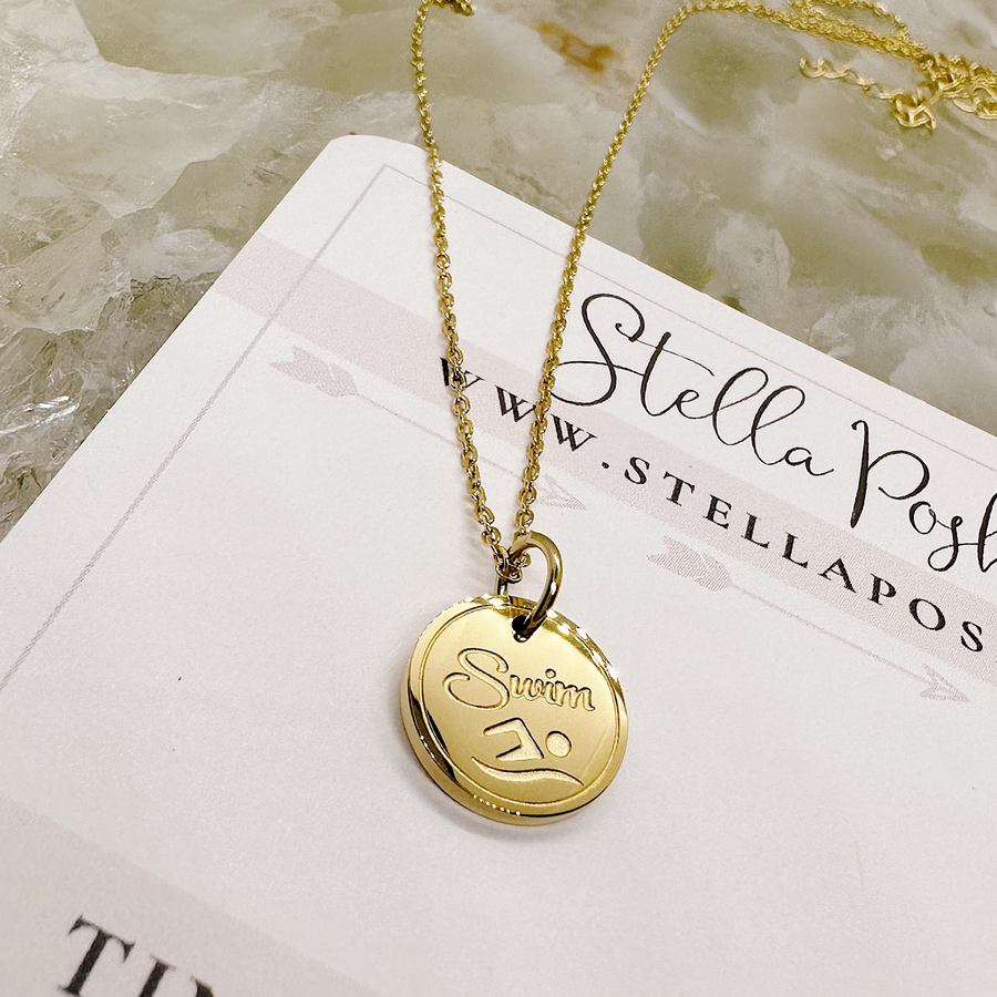 Gold swimmer disc charm necklace.