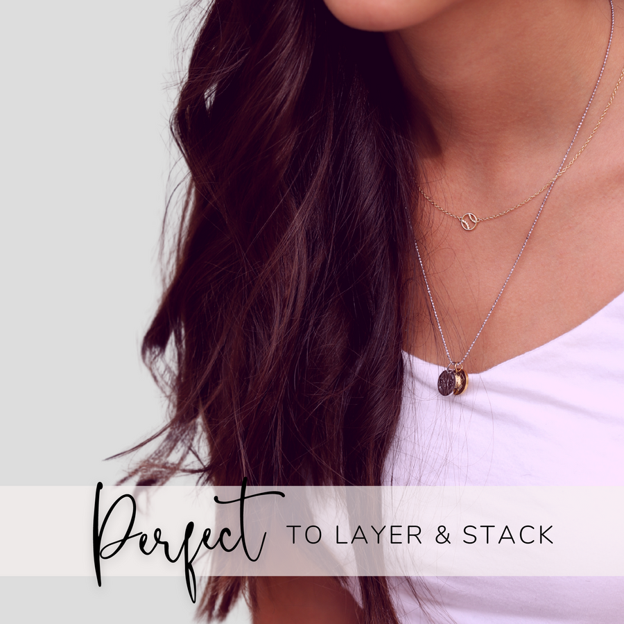 Model wearing Dainty Cross Country Necklace with Cross Country charm, and 'She believed she could so she did' charm, layered with .925 silver necklace.