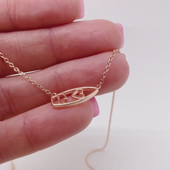 Video of .925 silver Surfboard Necklace held in hand for scale.