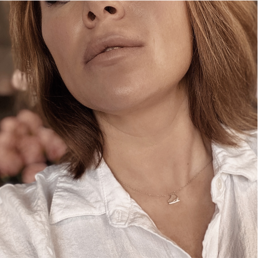 Model wearing .925 silver Dainty Ice Skate Necklace with premium cubic zirconias in a pavé setting.
