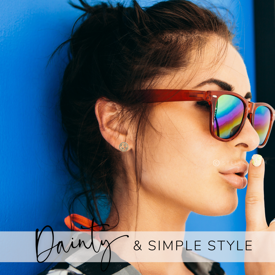 Model wearing tiny Soccer ball earrings.