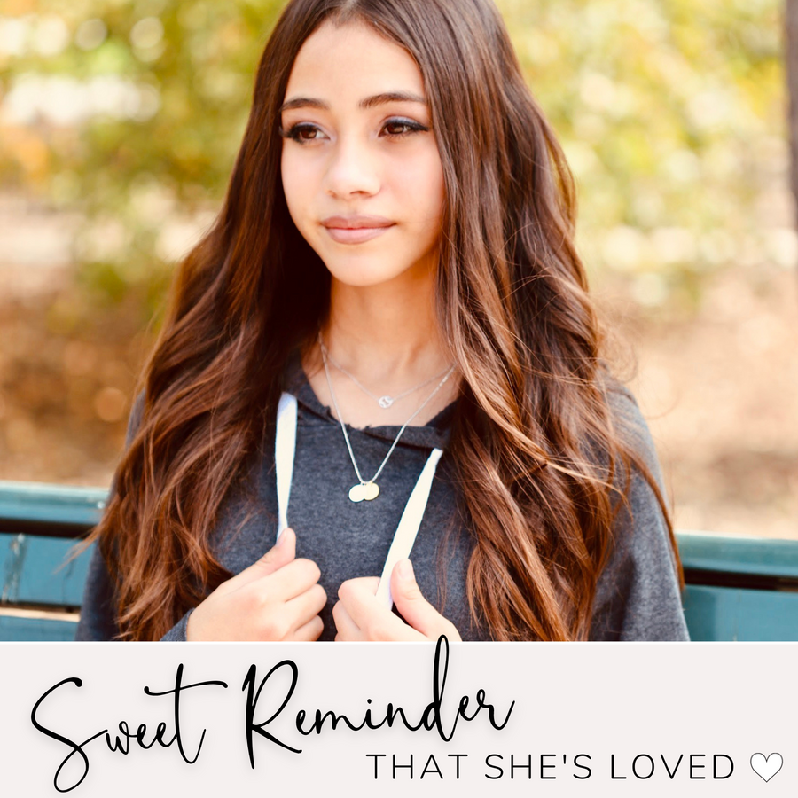 Model wearing the Charm Necklace, layered with a Baseball .925 Necklace. A Sweet Reminder that She's loved!