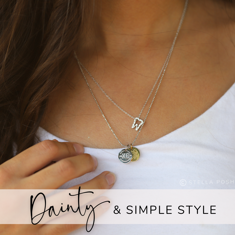Model wearing Dainty .925 silver Tooth Necklace, layered with Charm Necklace.