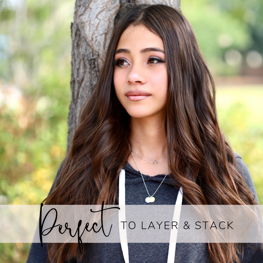 Brunette Teen Model wearing Dainty Dance Necklace with Dance charm, and 'She believed she could so she did' charm, layered with .925 silver necklace.