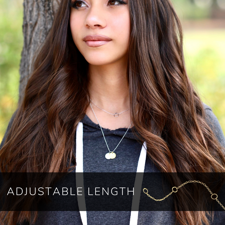 Model wearing tiny adjustable .925 silver Apple Necklace, layered with Charm Necklace.