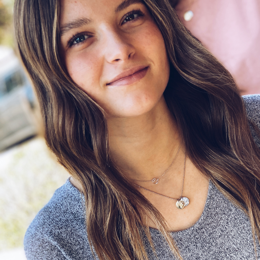  Model wearing Tiny .925 silver Tennis Necklace, layered with a Charm Necklace.