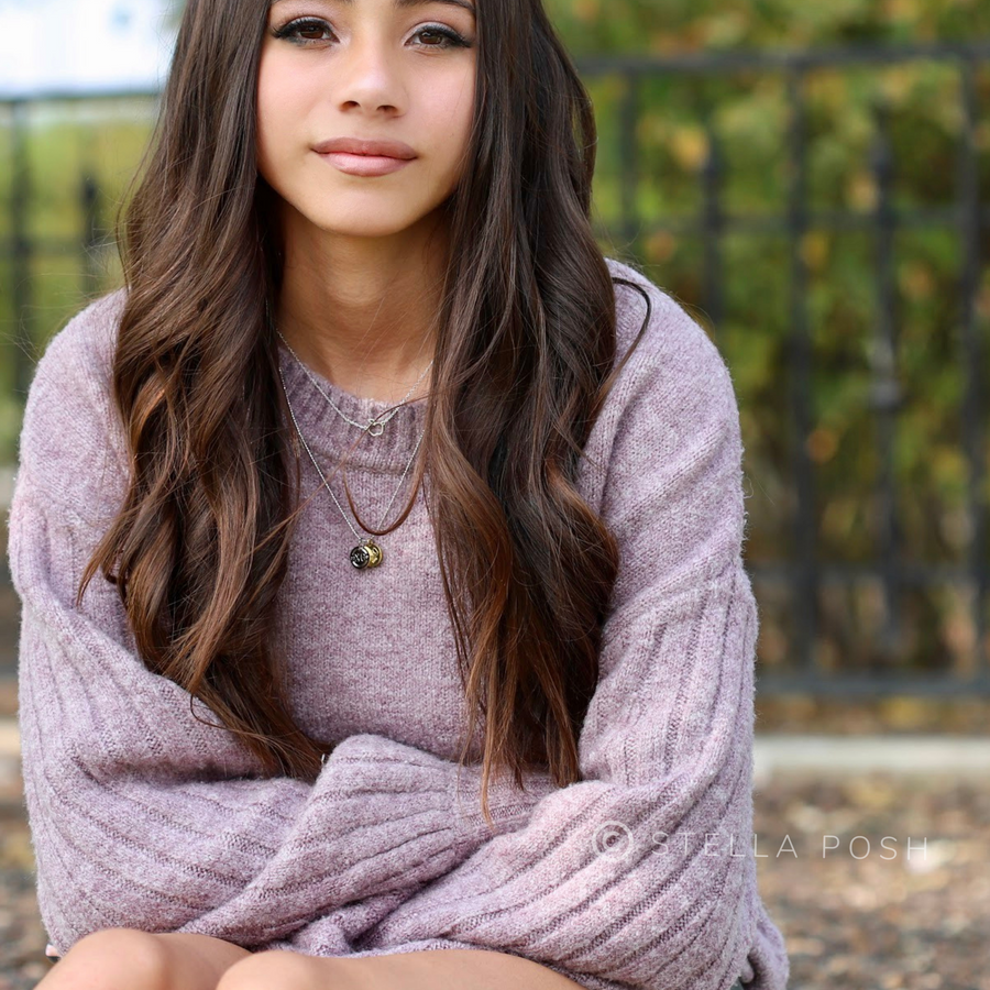 Model wearing tiny .925 silver Apple Necklace, layered with Charm Necklace.