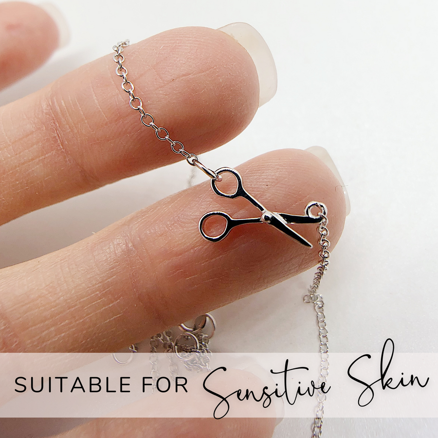 .925 silver Scissor Necklace held in hand for scale, and suitable for sensitive skin.