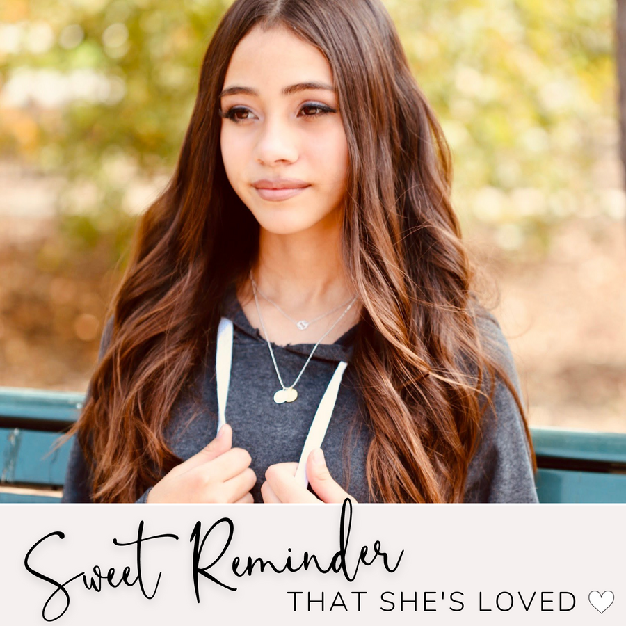 Brunette Teen Model wearing Dainty Gymnastics Necklace with Gymnastic charm, and 'She believed she could so she did' charm, layered with .925 silver necklace, a sweet reminder that she's loved.