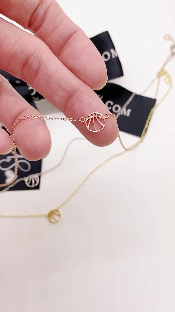 Dainty .925 Sterling Silver Basketball Necklace video with gold, silver, and rose gold necklaces.