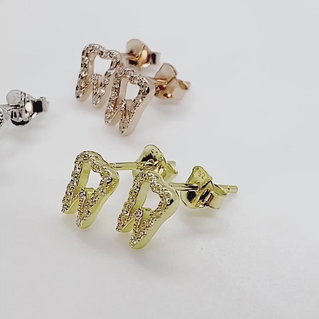 Video with Tiny .925 Sterling Silver Tooth Earrings with premium cubic zirconia stones in a pavé setting, in gold, silver, and rose gold.