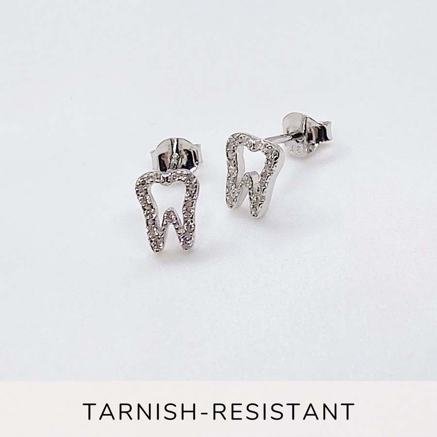 Tiny .925 Sterling Silver Tooth Earrings with premium cubic zirconia stones in a pavé setting.