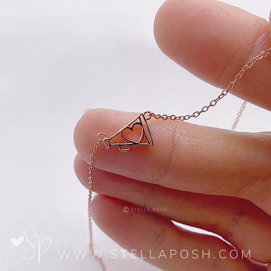 Tiny .925 Sterling Silver Cheer Necklace, held in hand for scale.