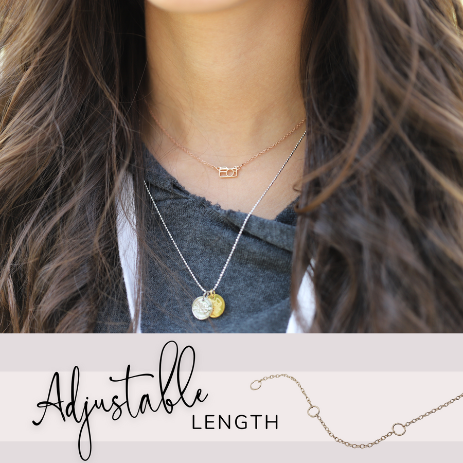 Model wearing .925 Sterling Silver Camera Necklace in gold, layered with Charm necklace.