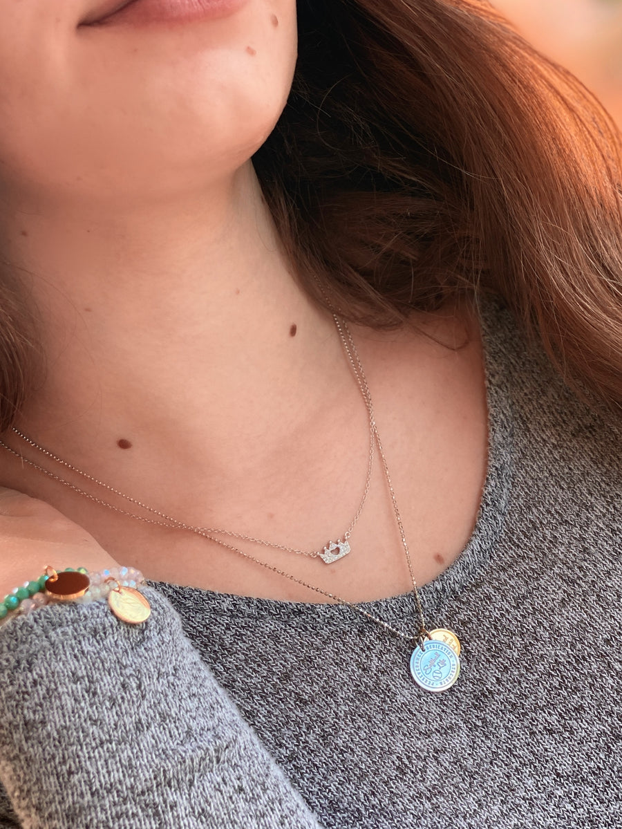Teen Model wearing Princess Crown .925 silver necklace with premium cubic zirconias, layered with charm necklace.