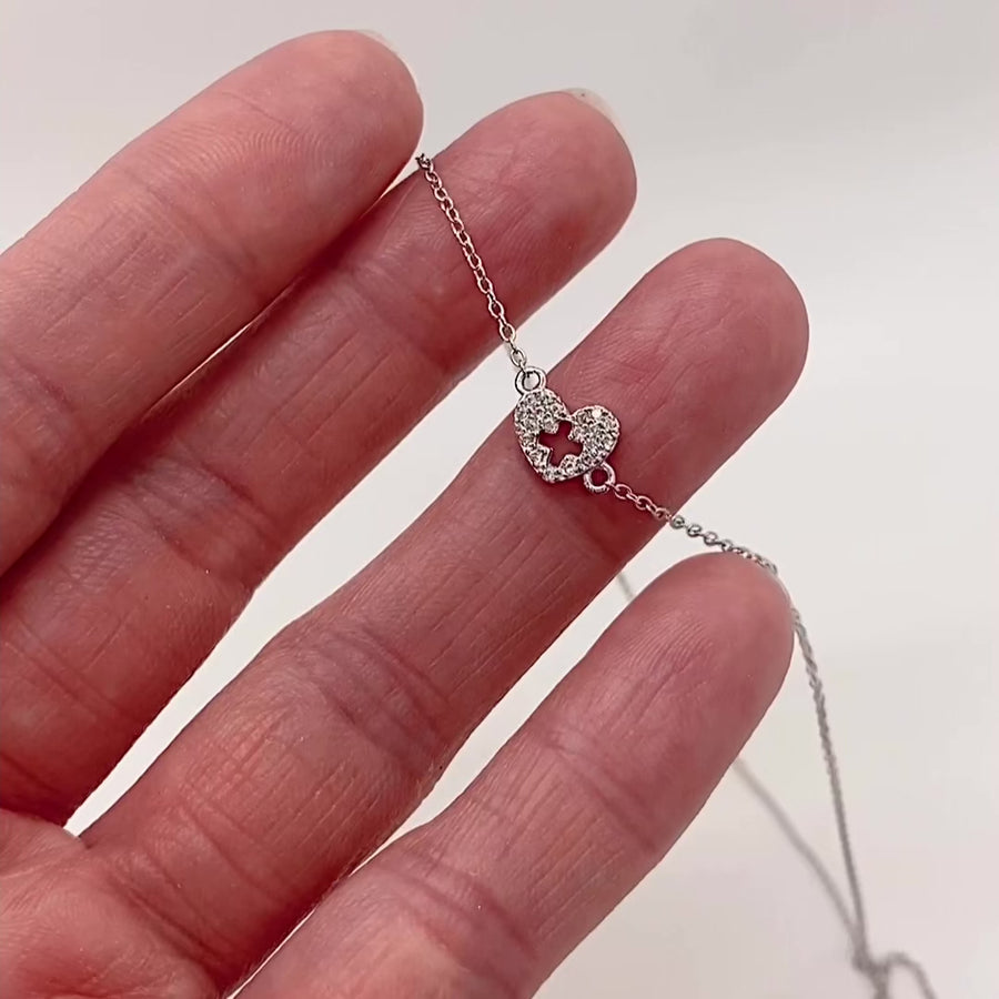Video of Tiny .925 silver Nurse Necklace with premium cubic zirconias.held in hand for scale.